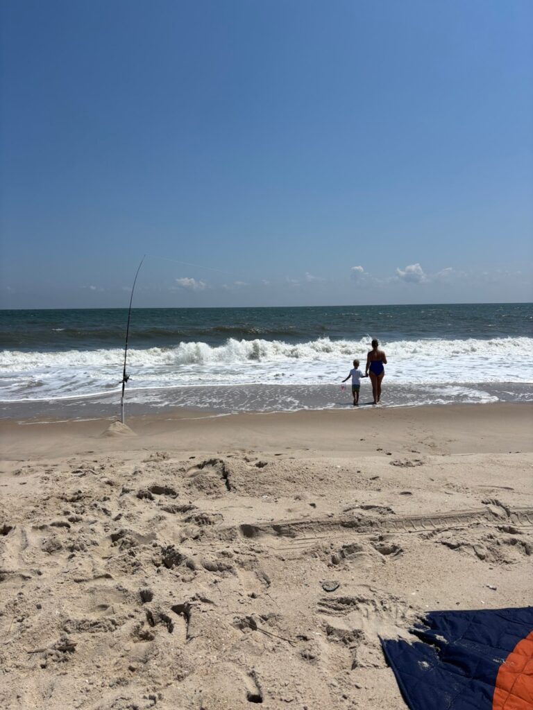 a couple of people fishing on a beach (MyCoast AI)