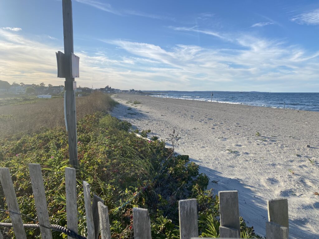 a beach with a fence and a sign (MyCoast AI)