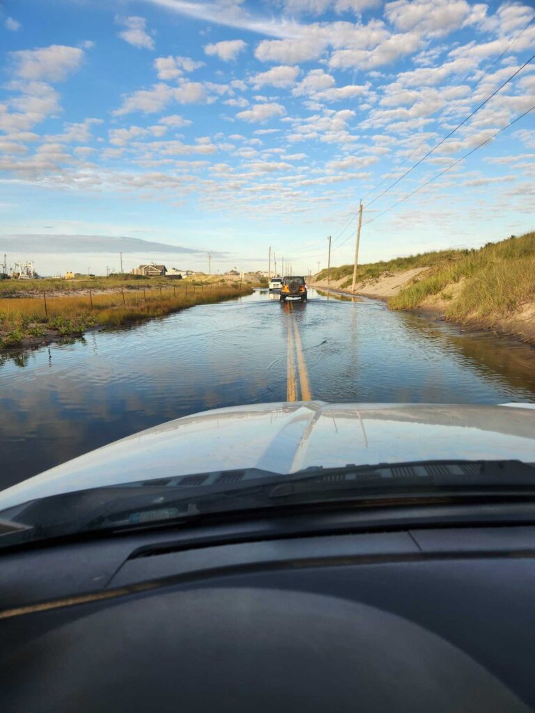 a car driving on a flooded road (MyCoast AI)