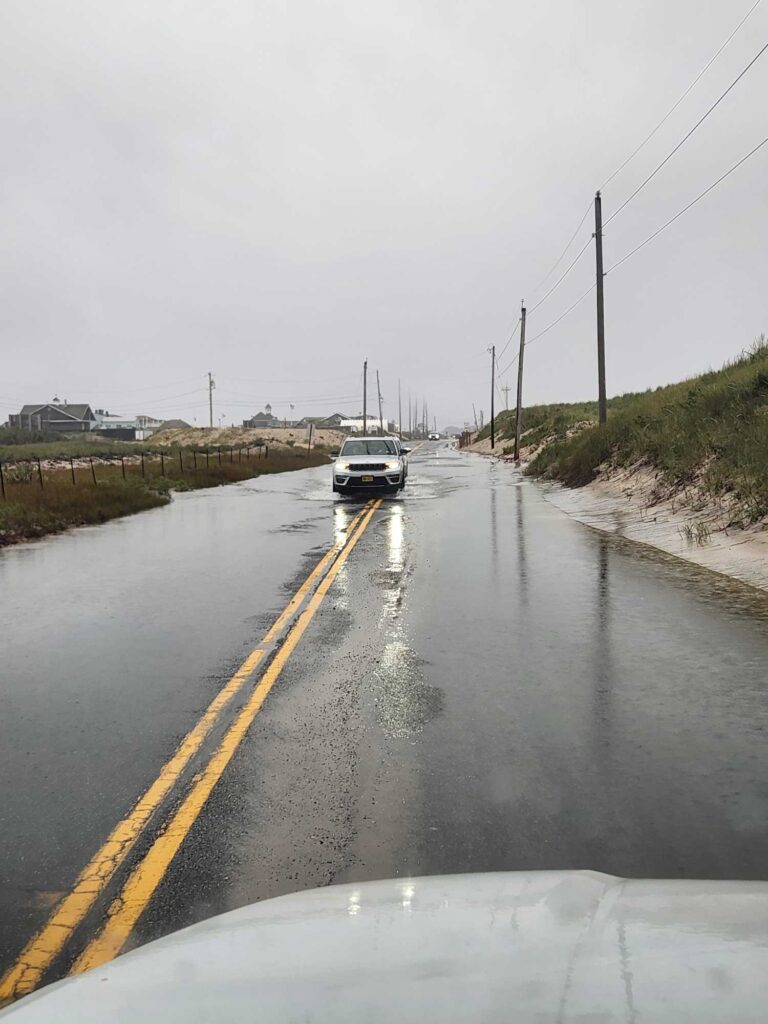 a car driving down a wet road (MyCoast AI)