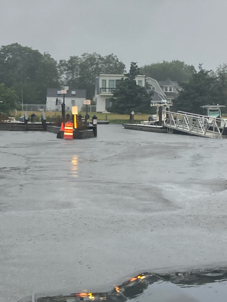 a flooded area with a dock and a house in the background (MyCoast AI)