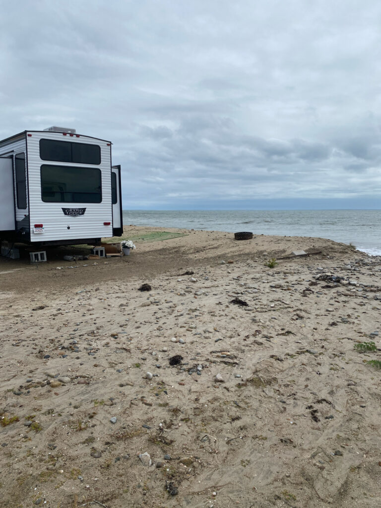 a white bus parked on a beach (MyCoast AI)
