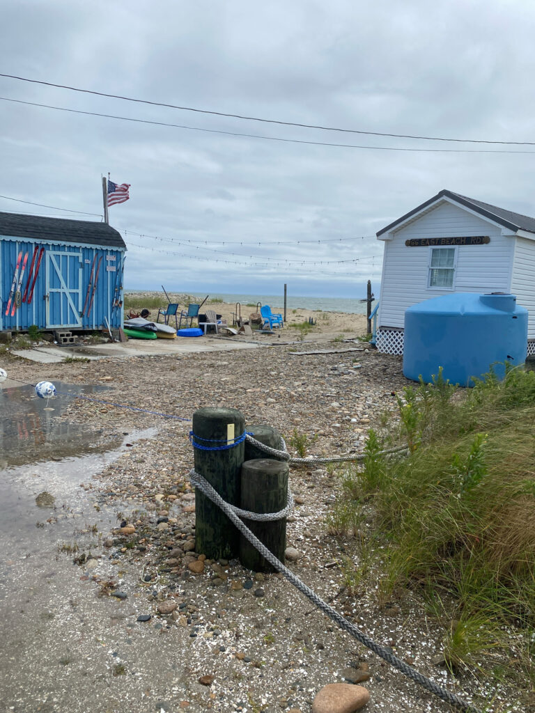 a group of blue and white buildings next to a beach (MyCoast AI)