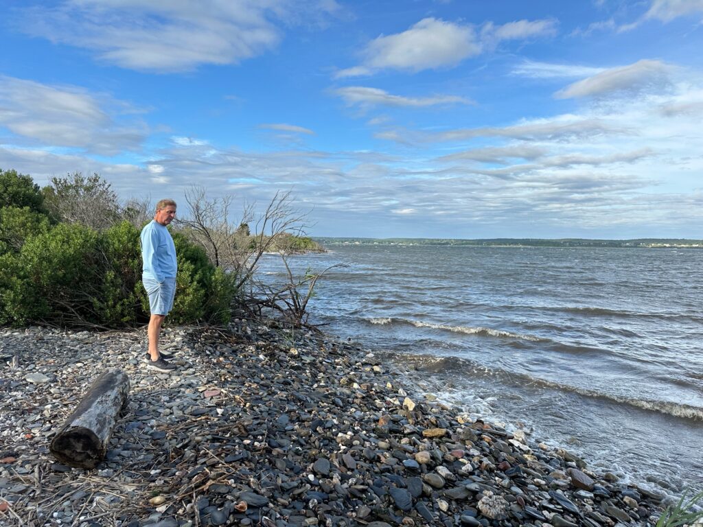 a man standing on a rocky beach (MyCoast AI)