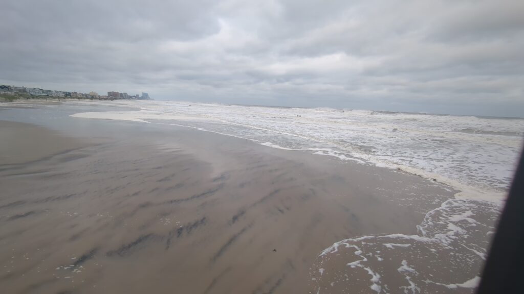 a beach with waves crashing on it (MyCoast AI)