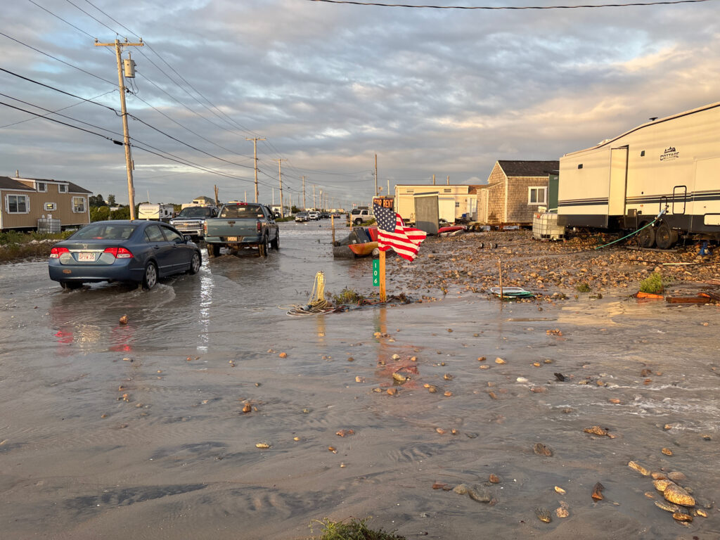 a flooded street with cars and a flag on it (MyCoast AI)