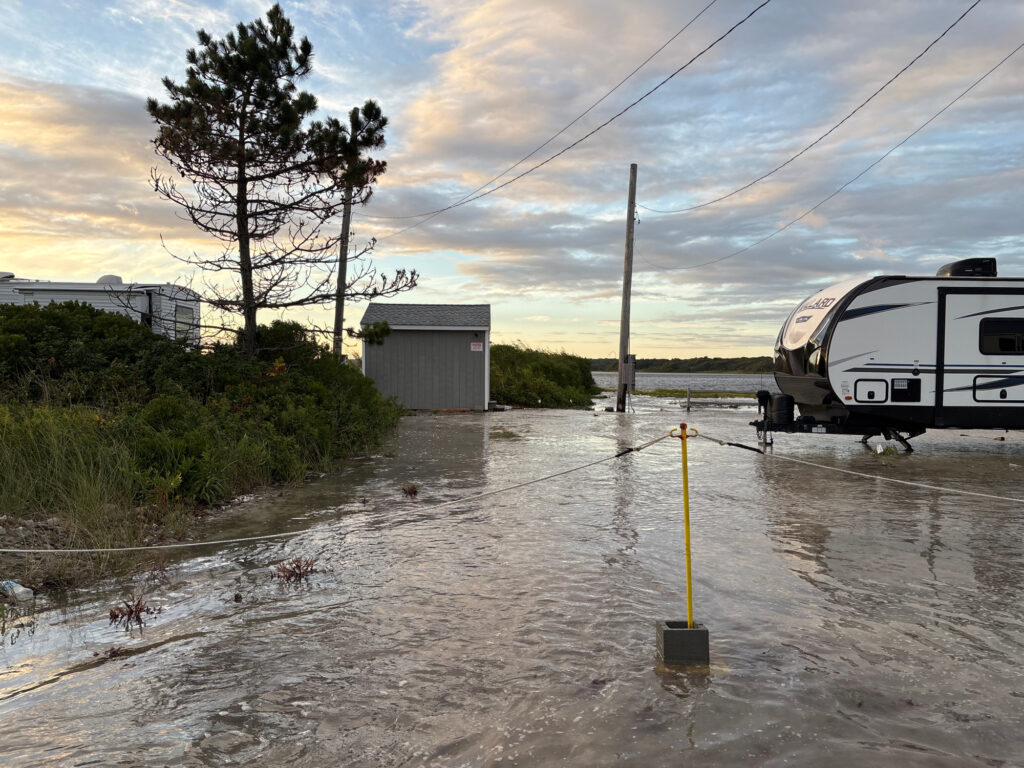 a flooded area with a bus and a car parked on the side (MyCoast AI)