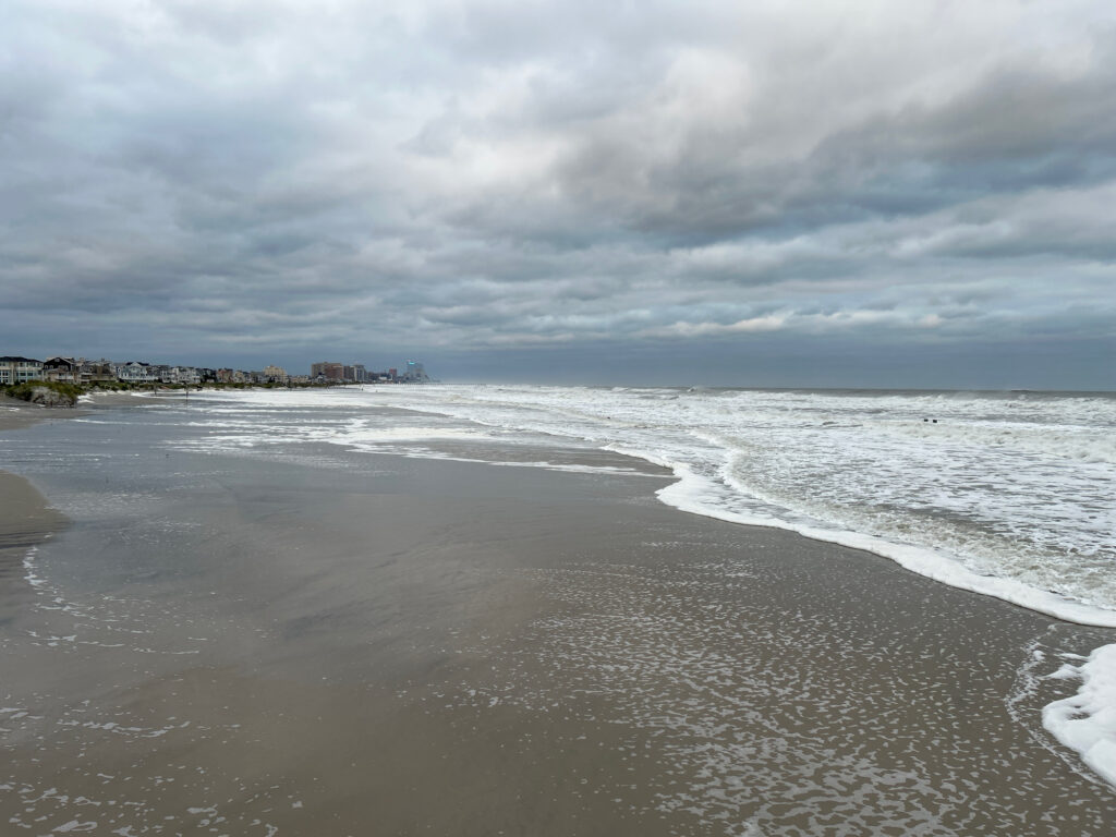 a beach with waves crashing on it (MyCoast AI)