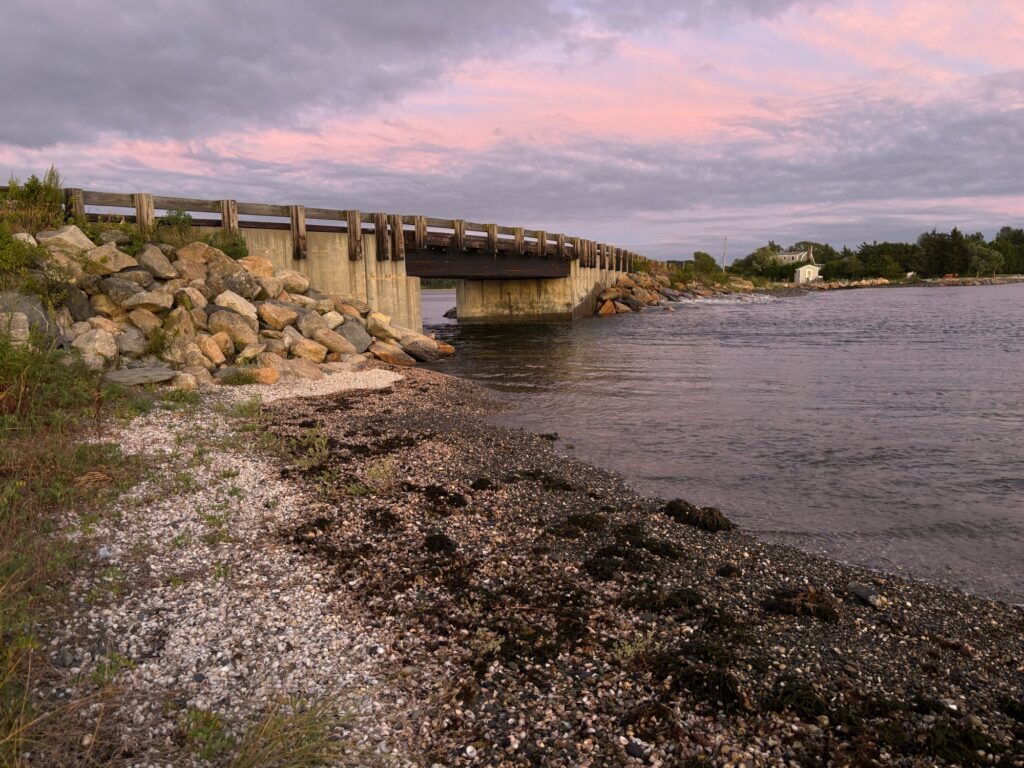 a rocky beach with a bridge (MyCoast AI)