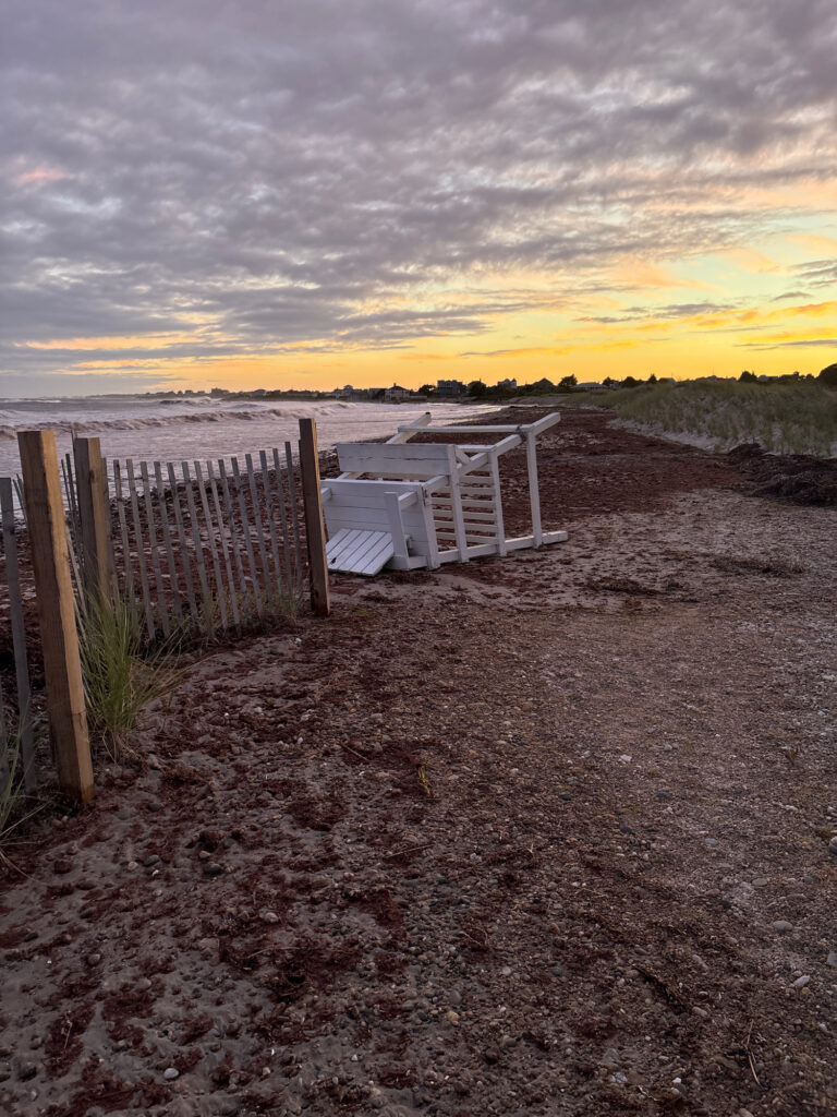 a beach with a fence and a sunset (MyCoast AI)