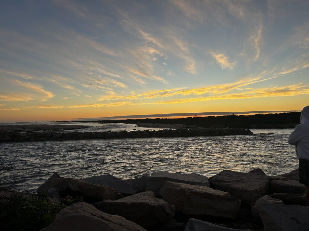 a rocky beach with a sunset (MyCoast AI)