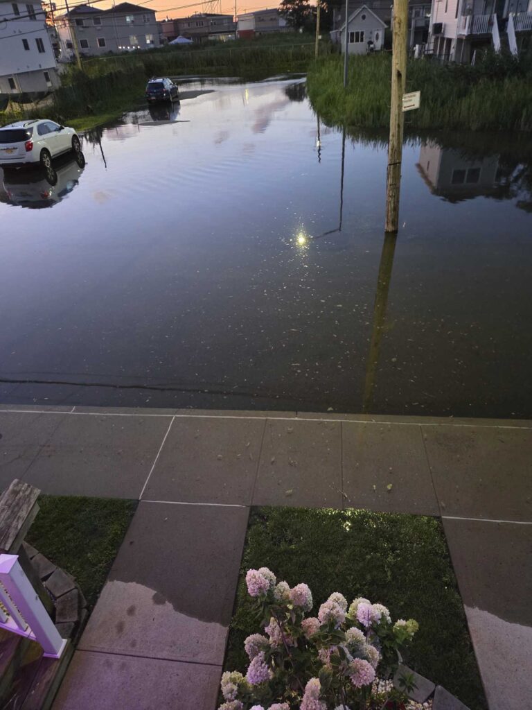a flooded street with a car parked on the side (MyCoast AI)