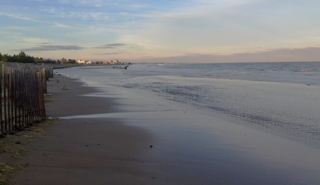a beach with a fence and water (MyCoast AI)