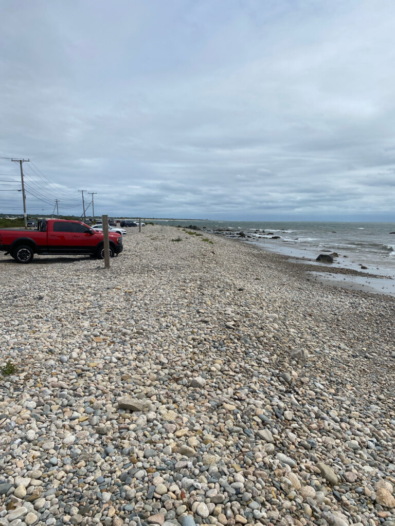 a red truck parked on a rocky beach (MyCoast AI)