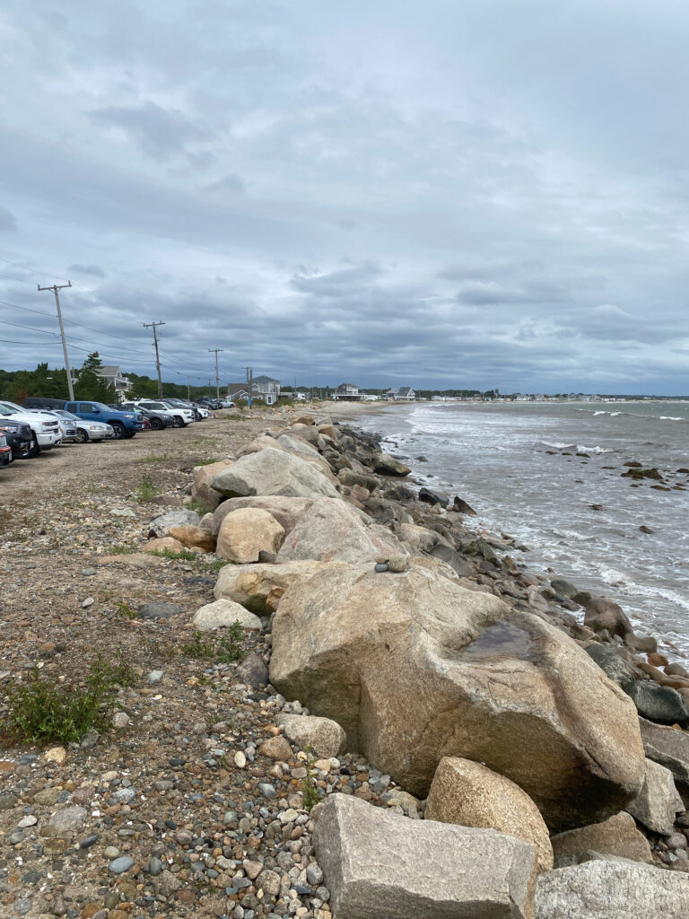 a rocky beach with cars parked on the side (MyCoast AI)