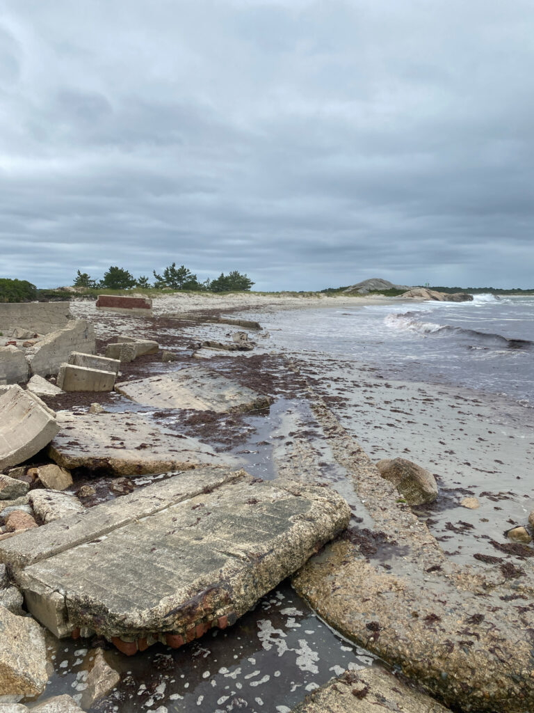 a rocky beach with a body of water and a cloudy sky (MyCoast AI)