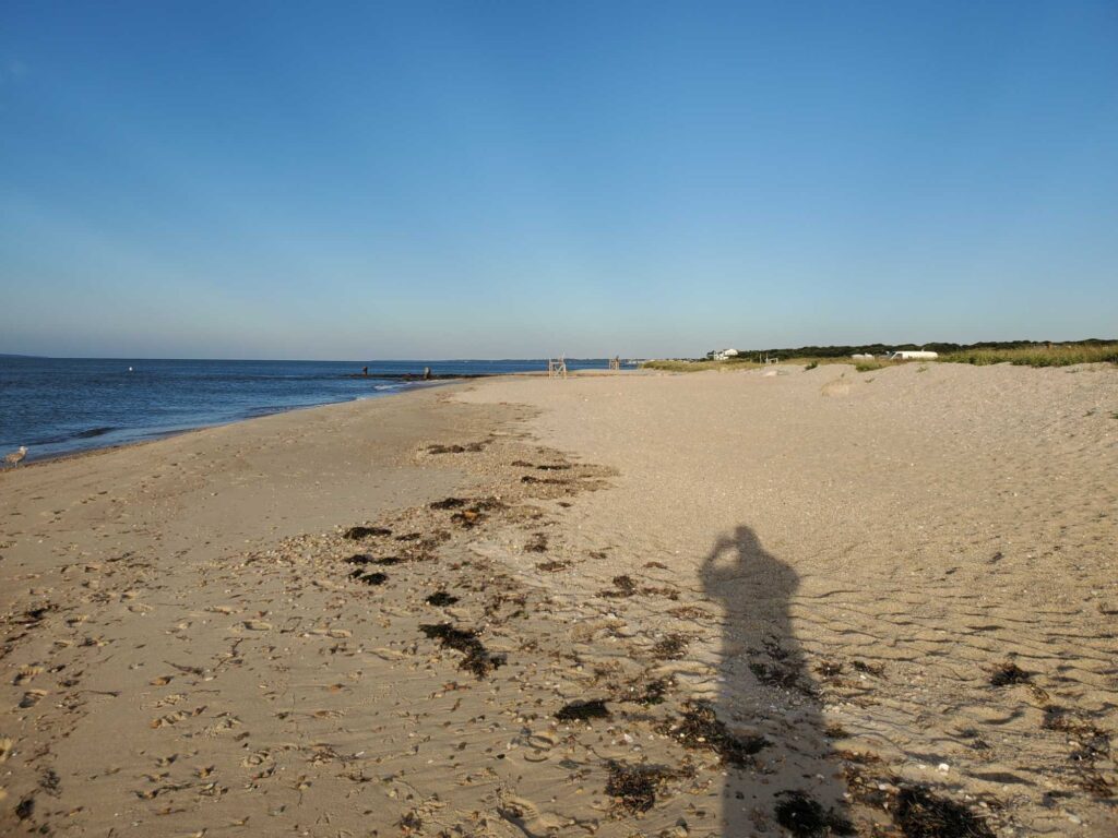 a person's shadow on a sandy beach (MyCoast AI)