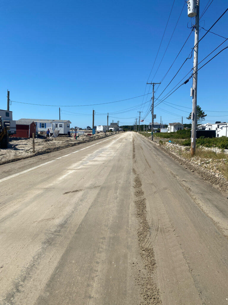 a dirt road with buildings on the side with Los Angeles River in the background (MyCoast AI)