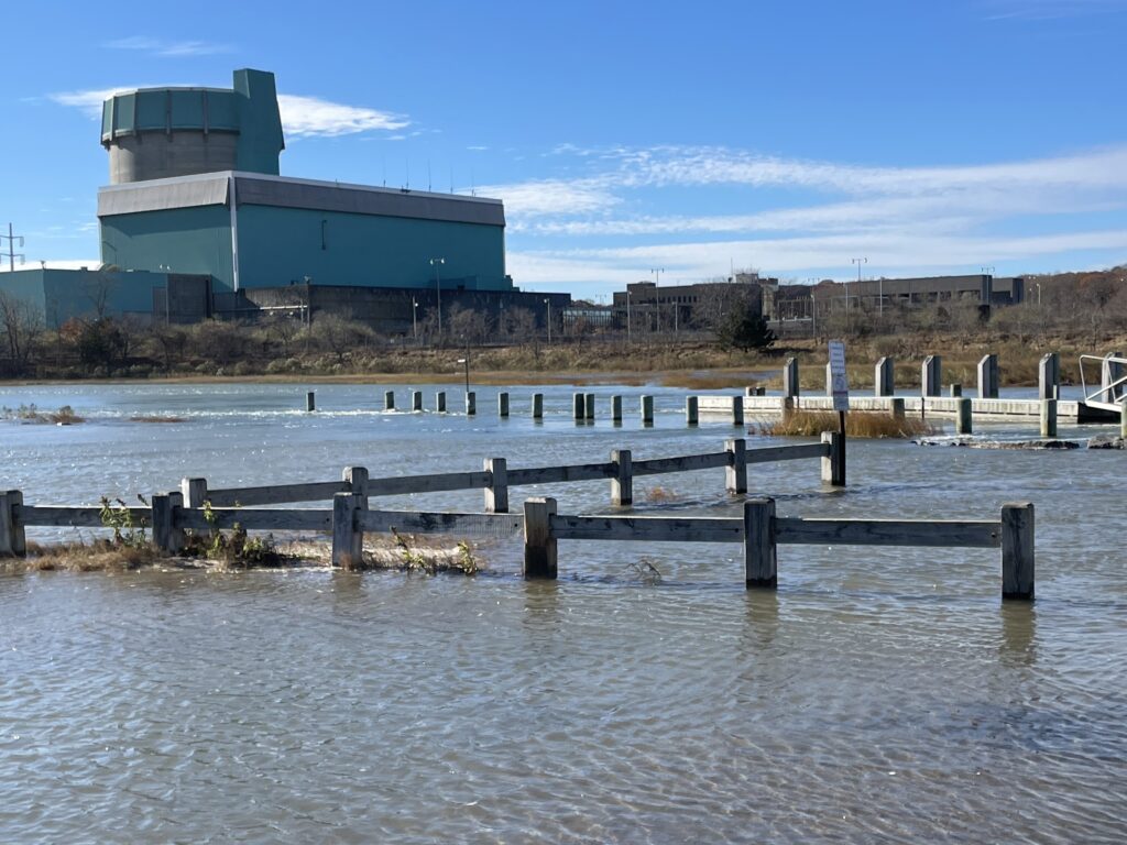 a body of water with a dock and buildings in the background (MyCoast AI)