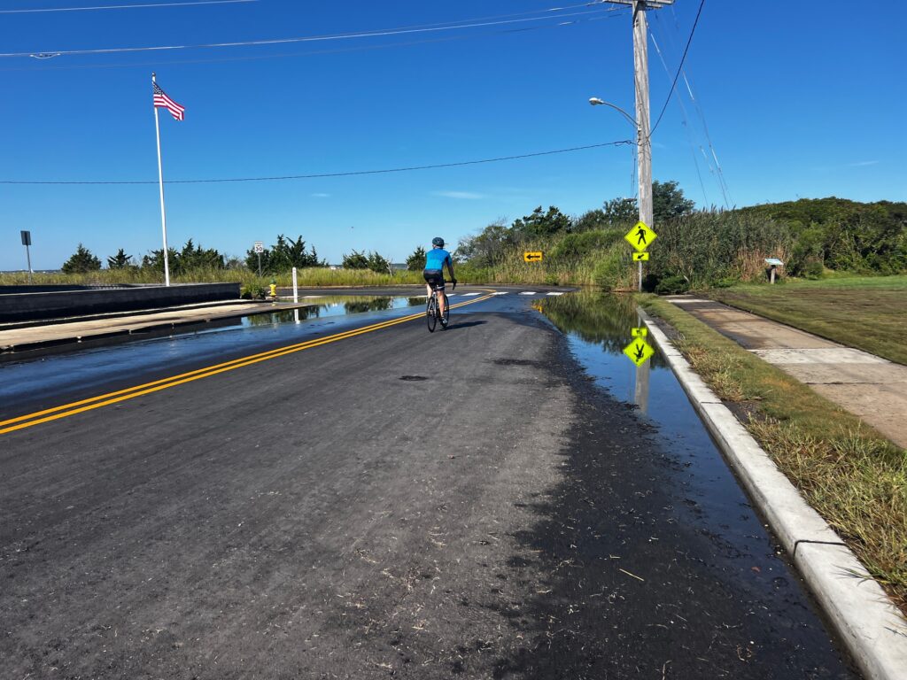 a person riding a bicycle on a road (MyCoast AI)