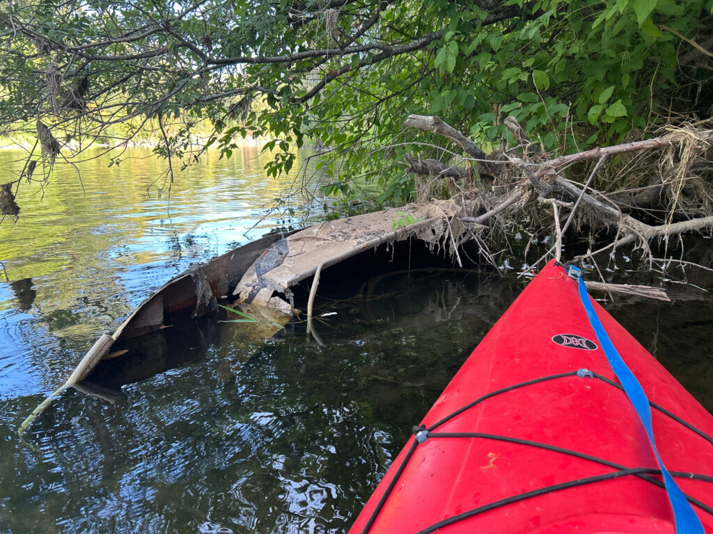 a red canoe on a river (MyCoast AI)