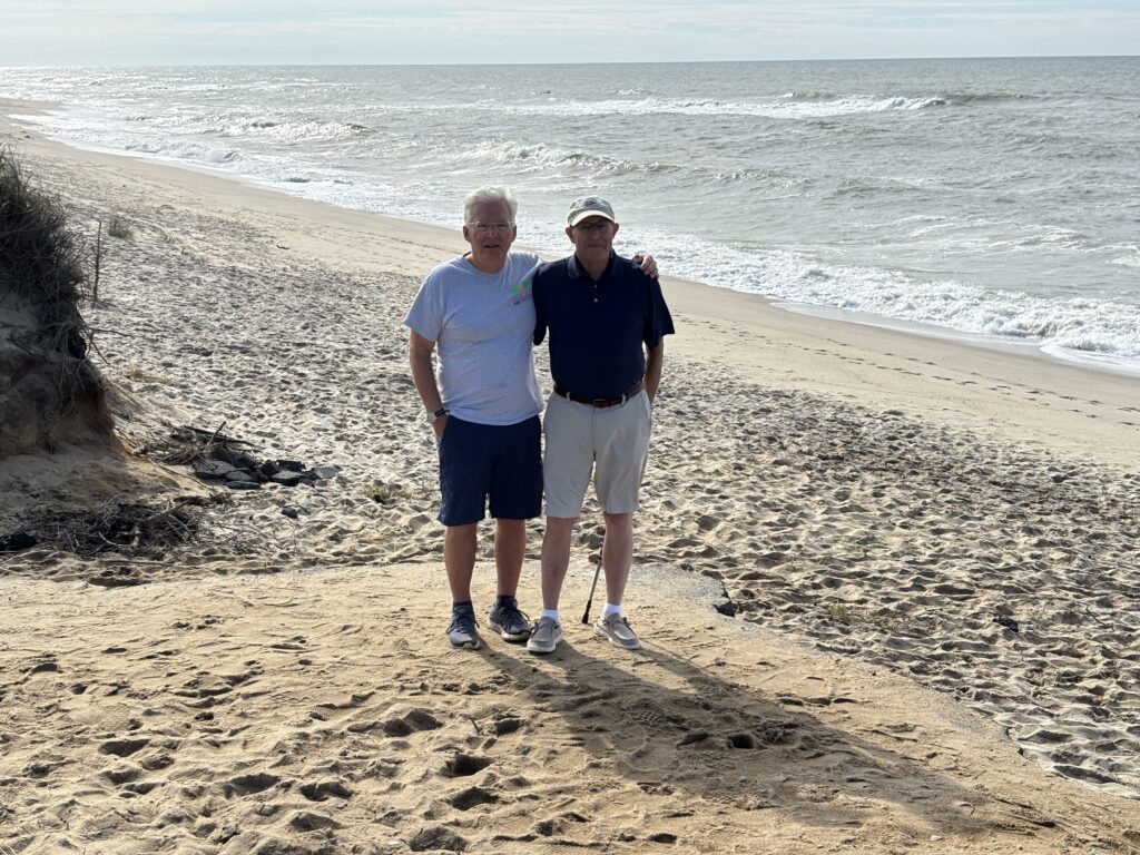 two men standing on a beach (MyCoast AI)