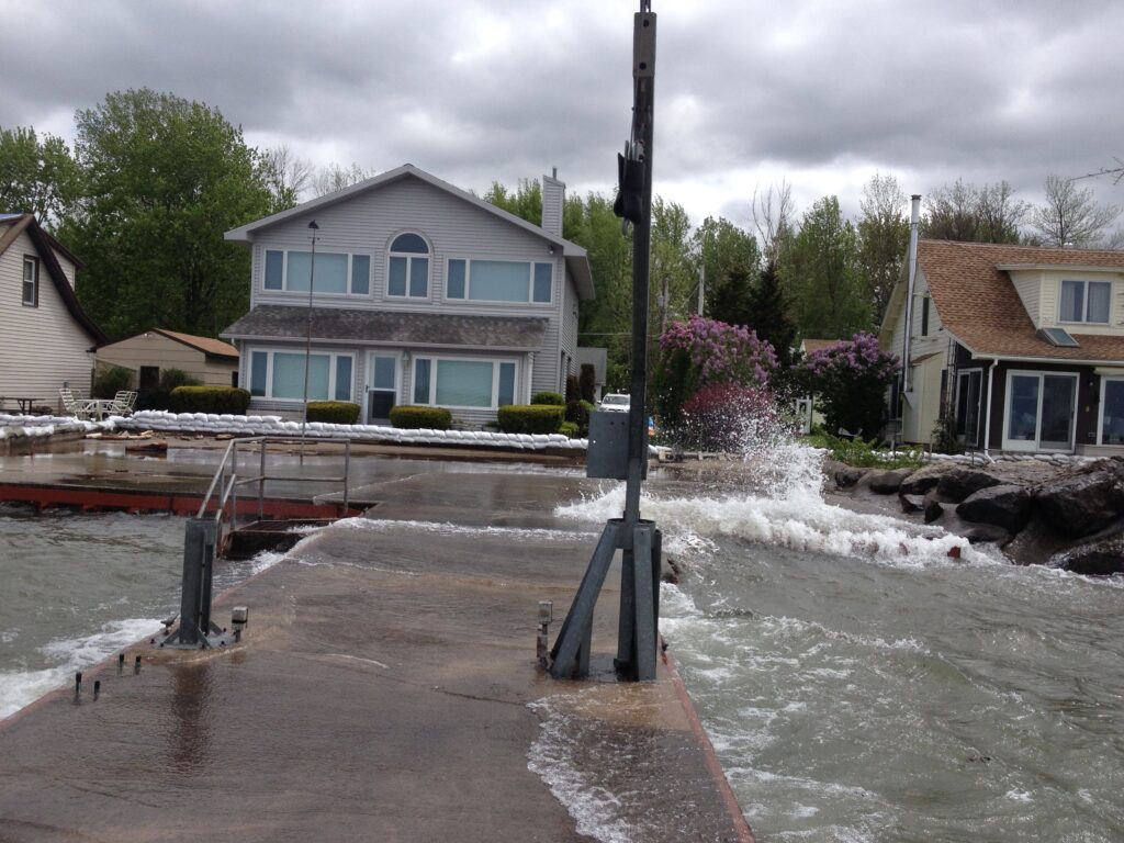 a flooded street with houses and trees (MyCoast AI)