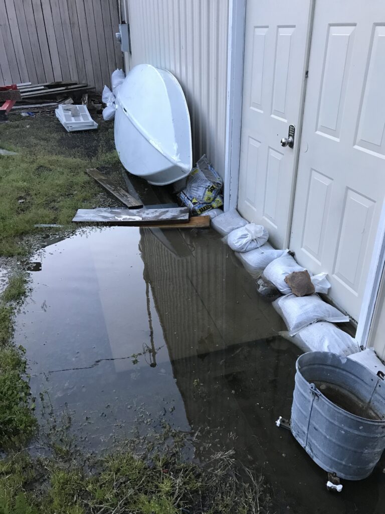 a toilet in a yard (MyCoast AI)
