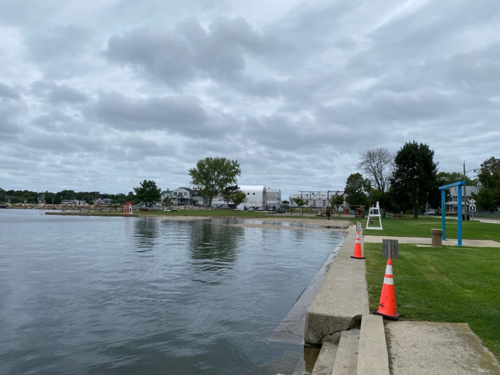 a body of water with a sidewalk and a sidewalk and grass around it (MyCoast AI)