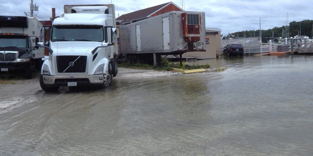 a group of trucks parked on the side of a river (MyCoast AI)