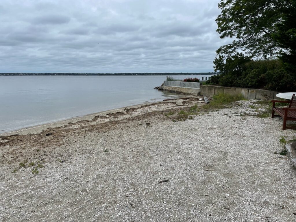 a beach with a bench and a body of water (MyCoast AI)