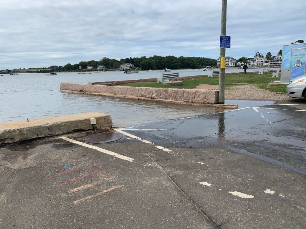 a road with a body of water and a road with a sign (MyCoast AI)