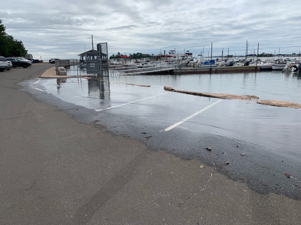 a body of water with boats in it and a dock and a building in the background (MyCoast AI)