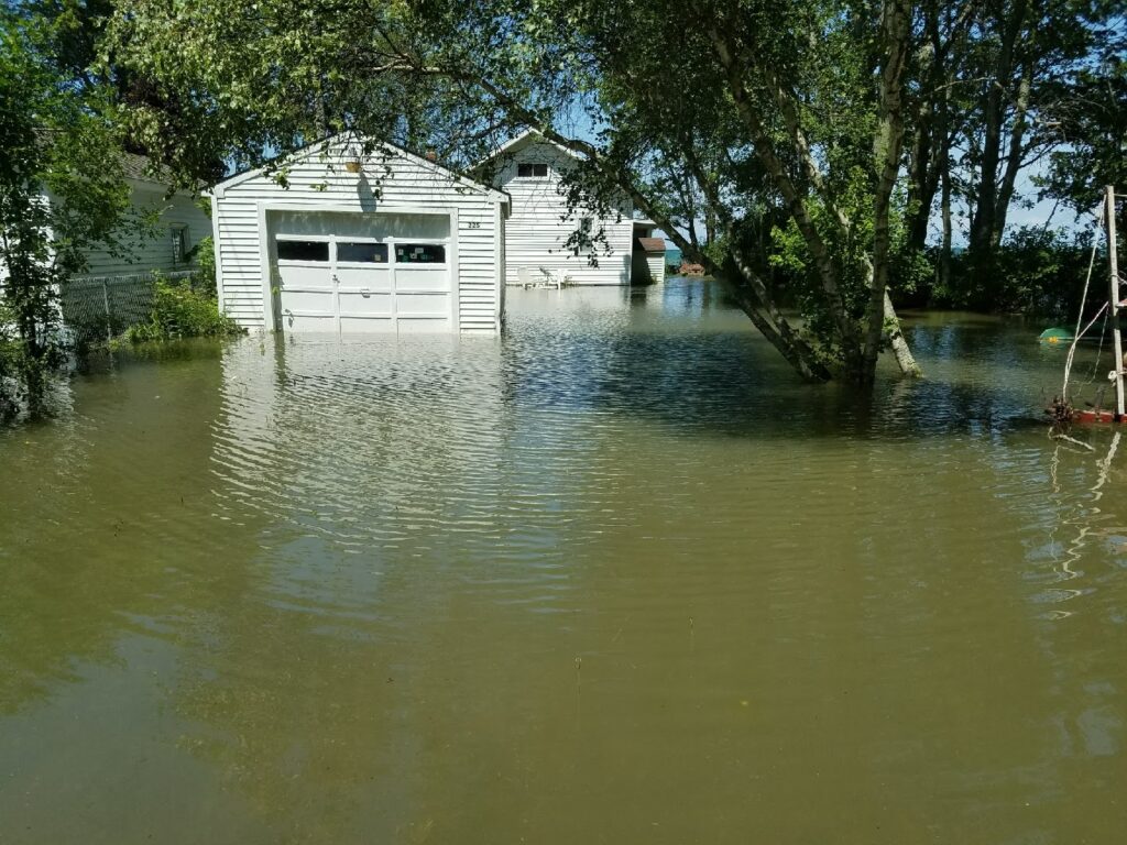 a flooded area with a house in the background (MyCoast AI)