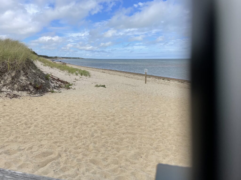 a sandy beach with a fence (MyCoast AI)