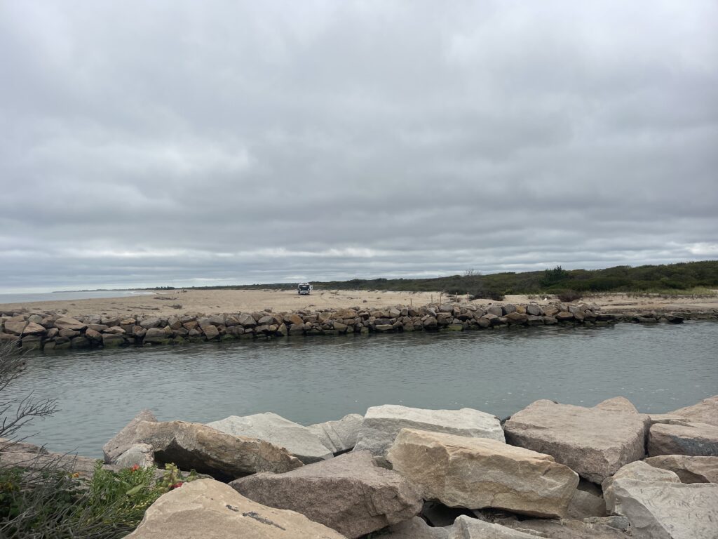 a body of water with rocks and a cloudy sky (MyCoast AI)