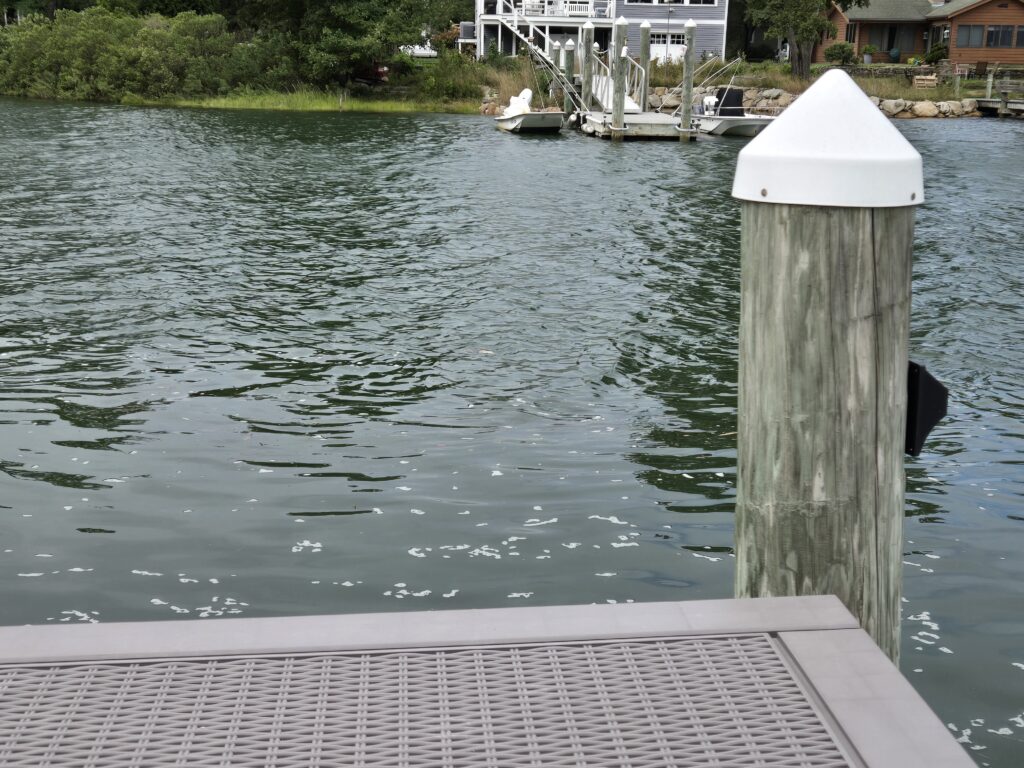 a wooden post in the water (MyCoast AI)