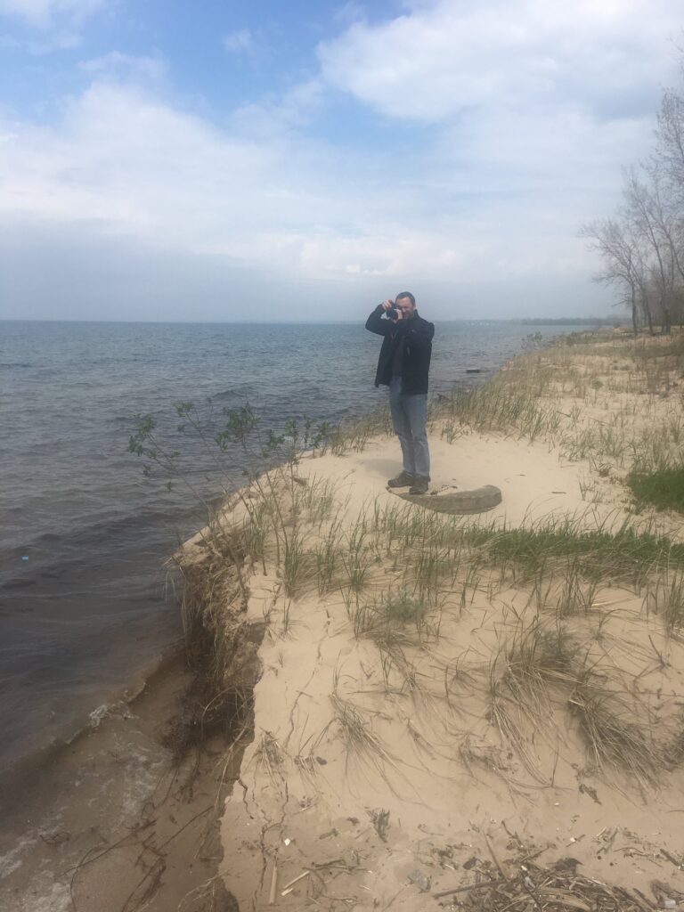 a man and woman standing on a beach (MyCoast AI)
