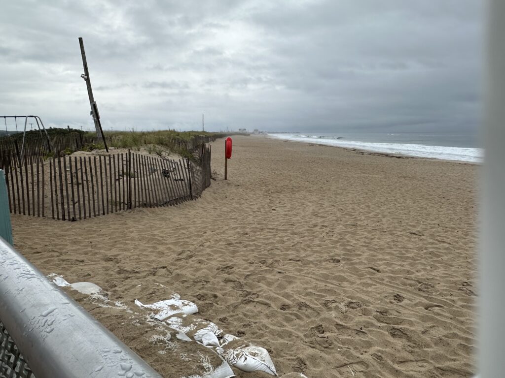 a sandy beach with a fence (MyCoast AI)