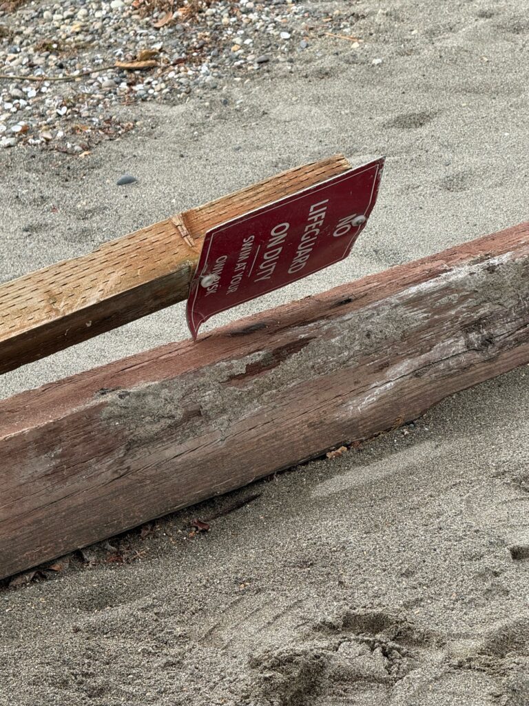 a wooden bench with a red sign (MyCoast AI)