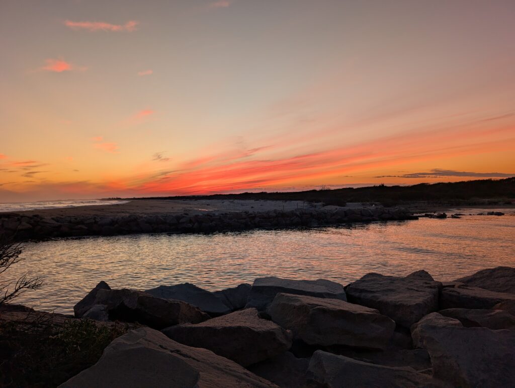 a rocky beach with a sunset (MyCoast AI)