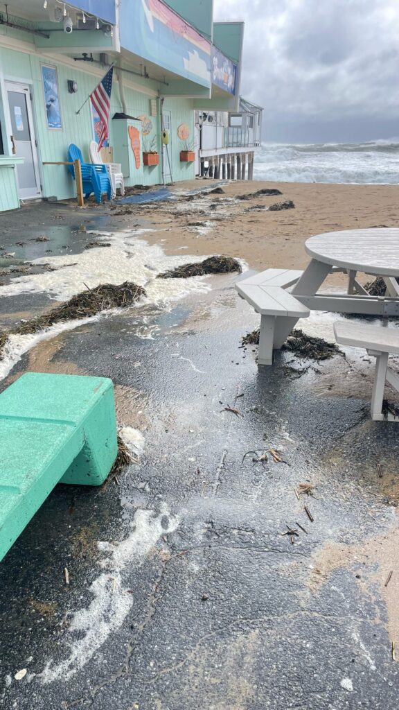 a beach with a row of tables and chairs (MyCoast AI)