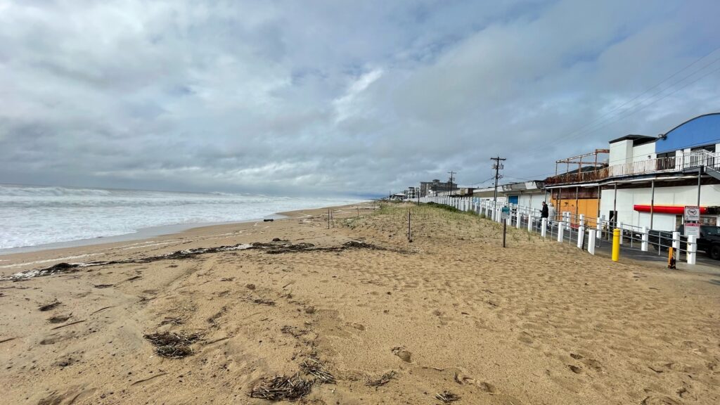 a sandy beach with buildings along it (MyCoast AI)
