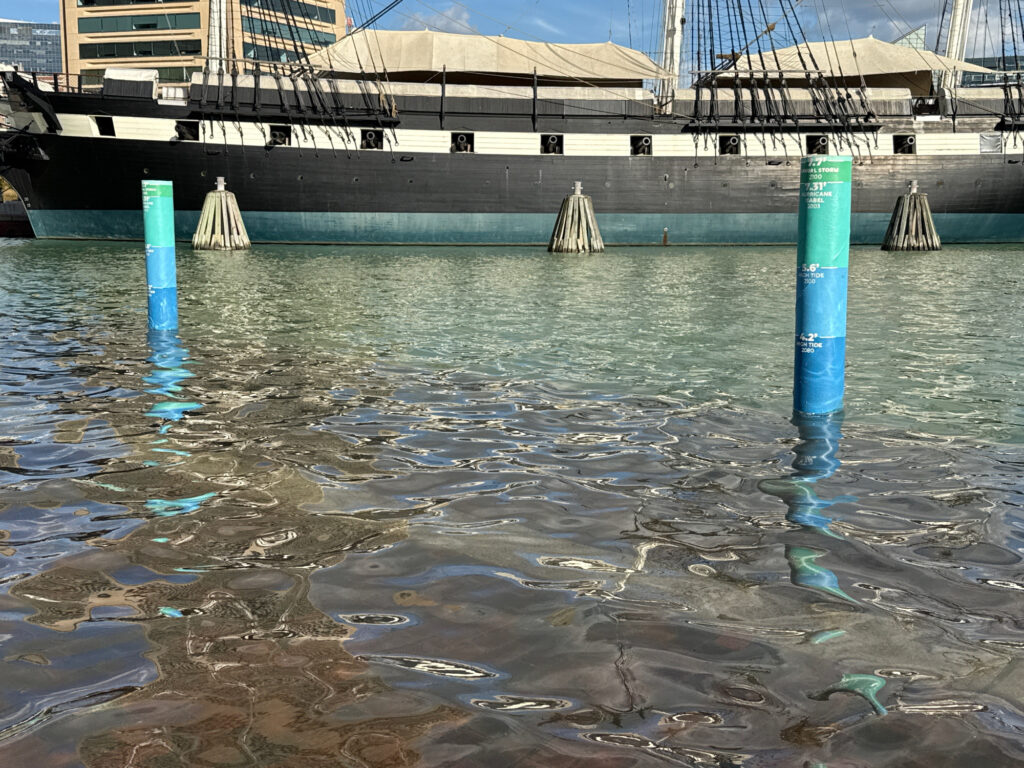 a body of water with a dock and a building in the background (MyCoast AI)