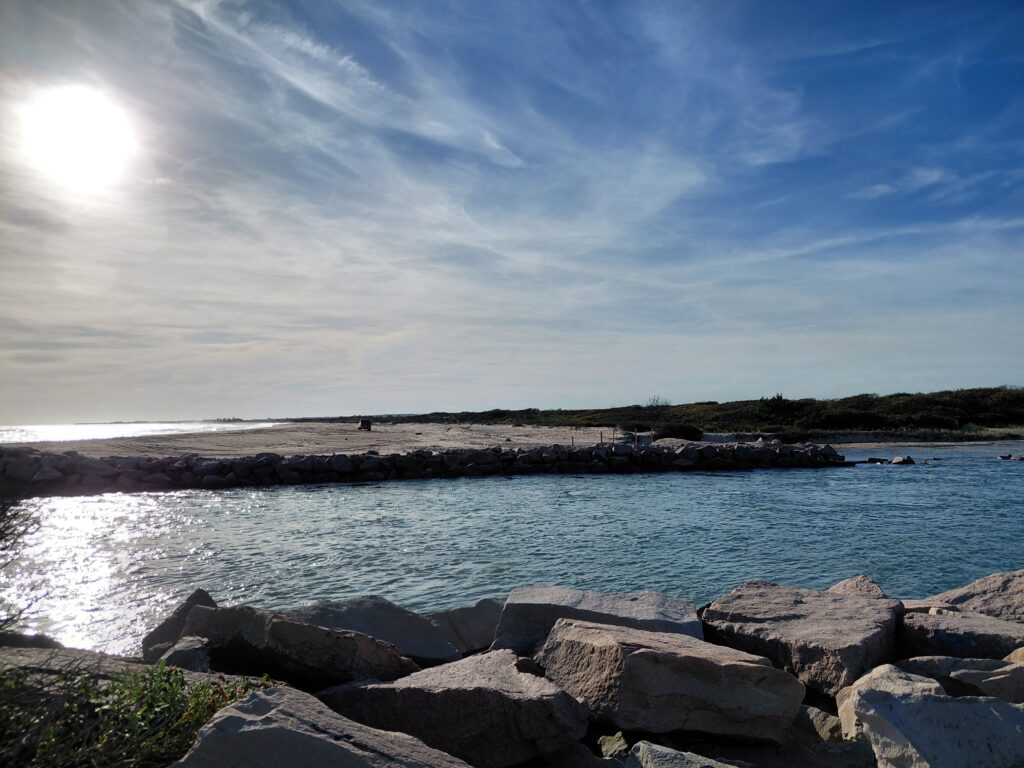 a rocky beach with a body of water and a sunny day (MyCoast AI)