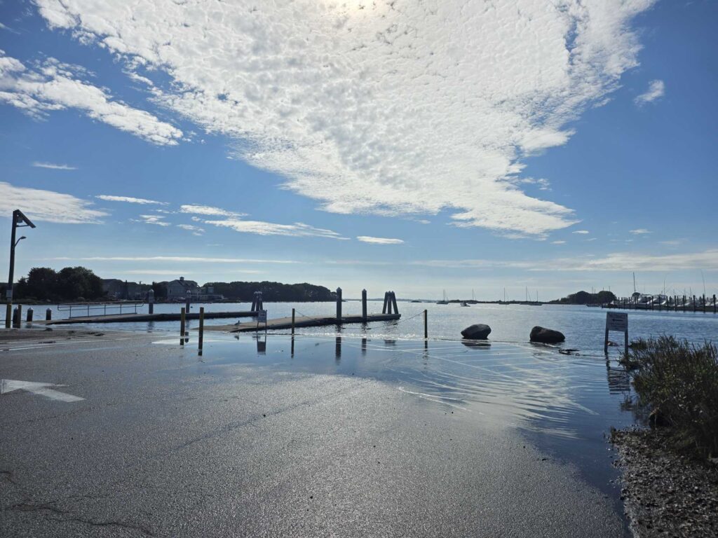 a body of water with a dock and a cloudy sky (MyCoast AI)