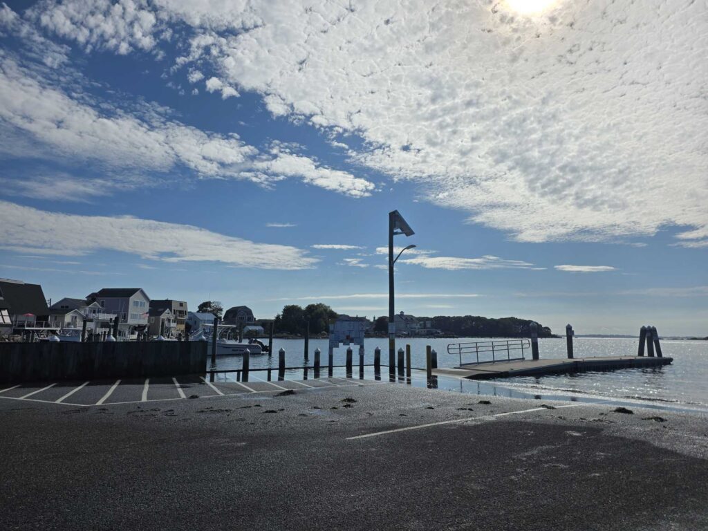 a beach with a pier and a flag (MyCoast AI)