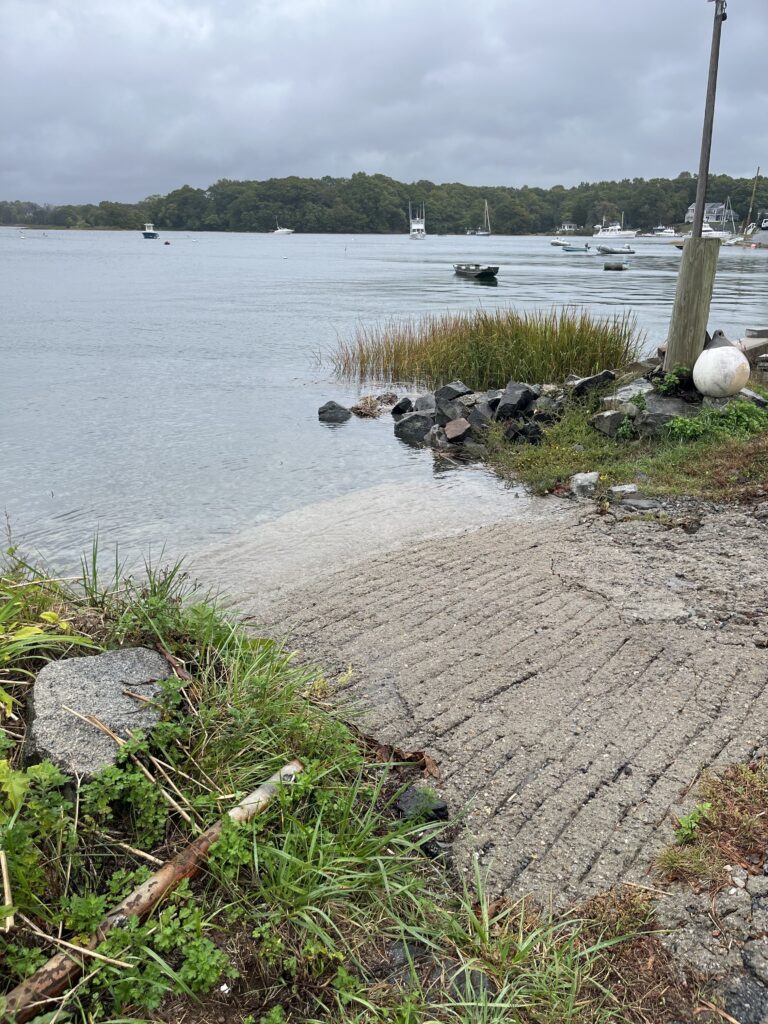 a rocky shore with boats in the water (MyCoast AI)