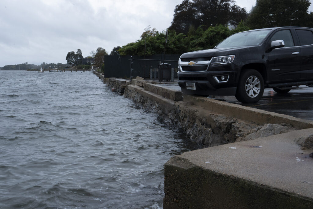 a car parked on a road next to a body of water (MyCoast AI)