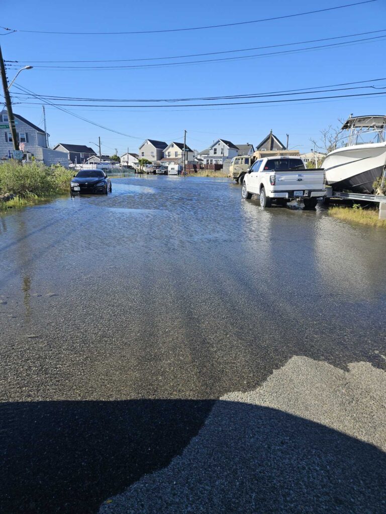 a flooded street with cars and houses (MyCoast AI)